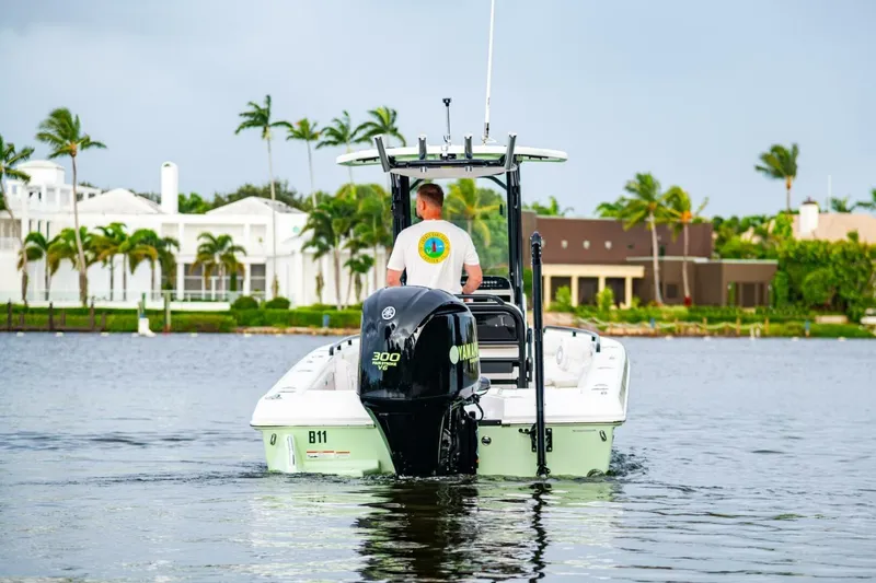 Slide: The Image of 2018 Everglades 243 Center Console boat on water, palm trees and houses in background. - 5