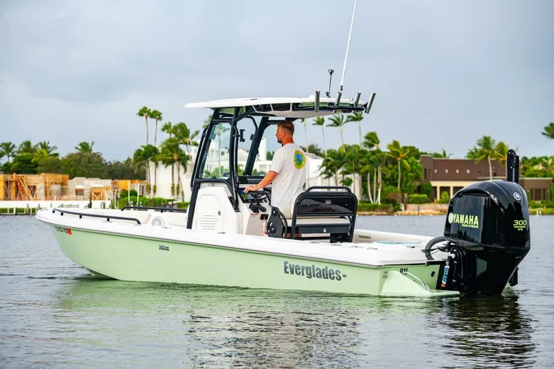 Slide: The Image of 2018 Everglades 243 Center Console boat on water, with Yamaha engine, tropical background. - 7