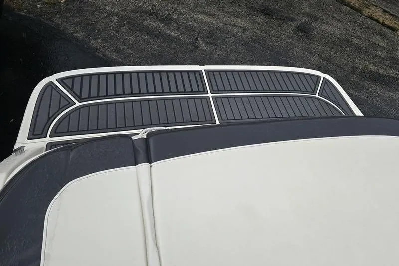 Slide: The Image of 2021 Bayliner VR5 Cuddy boat deck with sleek black and white design. - 14