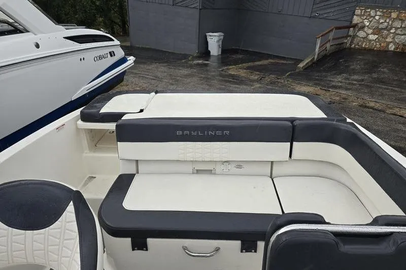 Slide: The Image of 2021 Bayliner VR5 Cuddy boat interior with cushioned seating and storage. - 16