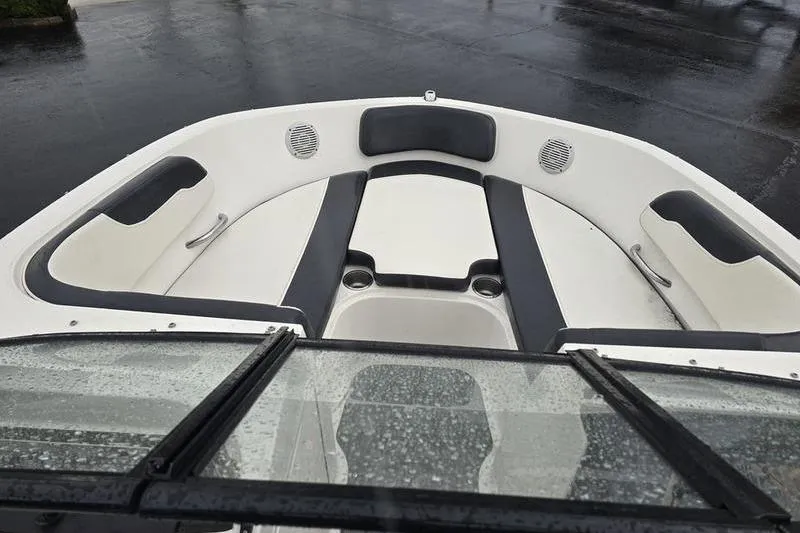 Slide: The Image of 2021 Bayliner VR5 Cuddy boat interior with cushioned seating and cup holders. - 17