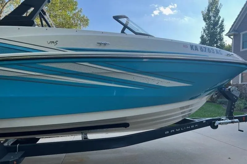 Slide: The Image of 2021 Bayliner VR5 Cuddy boat on trailer, parked outdoors on a rainy day. - 4