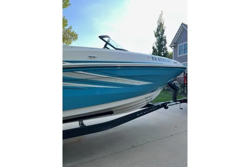 Slide: The Image of 2021 Bayliner VR5 Cuddy boat interior with cushioned seating and sleek design. - 5