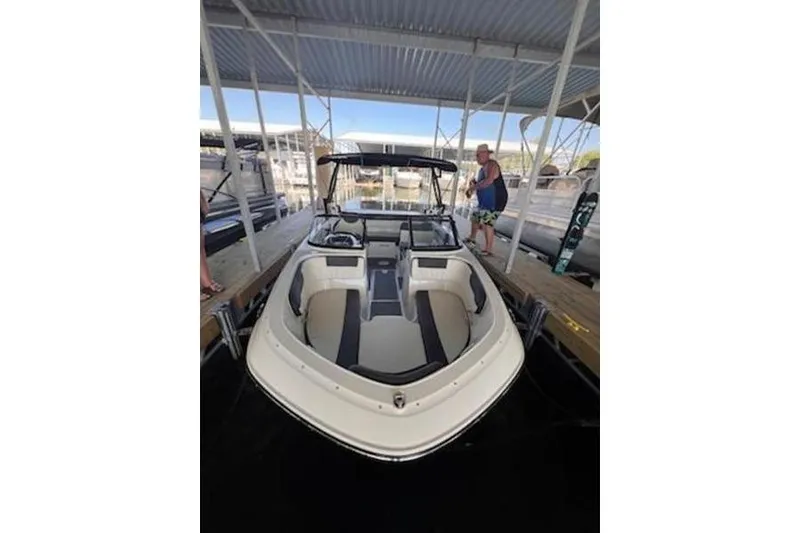 Slide: The Image of 2021 Bayliner VR5 Cuddy boat on trailer, rear view, with ladder and blue accents. - 6