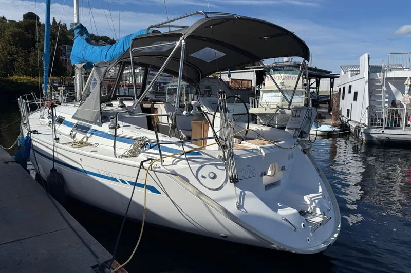 The Image of 2002 Bavaria 37 Sloop docked at marina, featuring sleek design and spacious deck. - 0