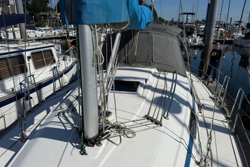 Slide: The Image of 2002 Bavaria 37 Sloop docked at marina, featuring deck and rigging details. - 1