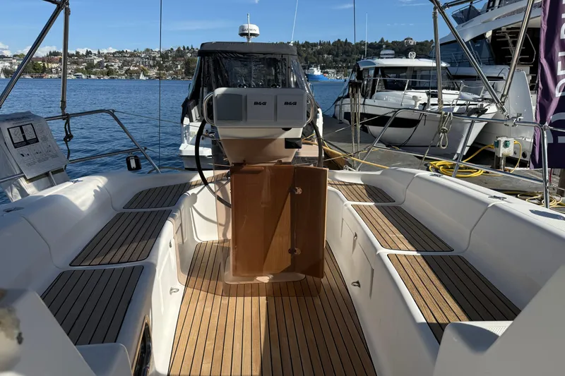 Slide: The Image of 2002 Bavaria 37 Sloop sailboat cockpit with wooden deck, docked at marina. - 12