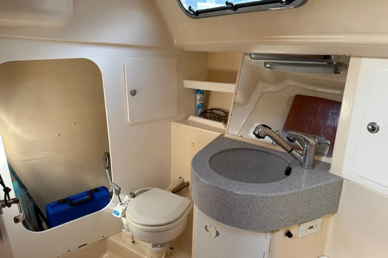 Slide: The Image of Interior of 2002 Bavaria 37 Sloop bathroom with sink, toilet, and storage. - 13