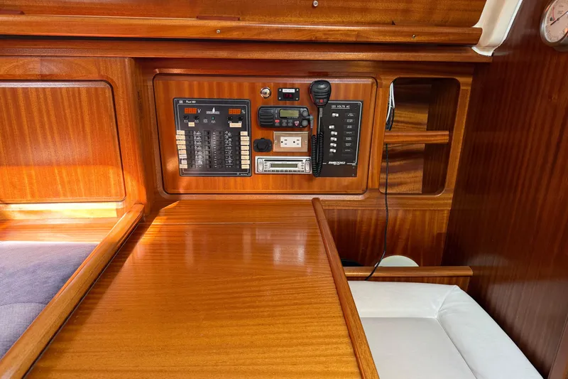 Slide: The Image of Control panel of a 2002 Bavaria 37 Sloop with wooden interior and navigation equipment. - 14