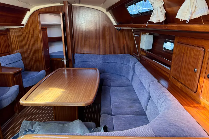 Slide: The Image of Interior of 2002 Bavaria 37 Sloop with wooden finish and blue seating. - 16