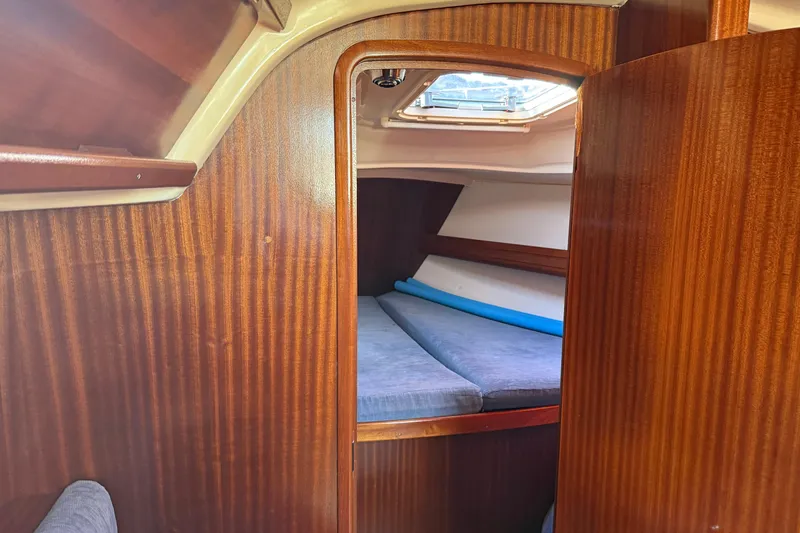 Slide: The Image of Interior cabin of 2002 Bavaria 37 Sloop with wooden finish and cozy sleeping area. - 19