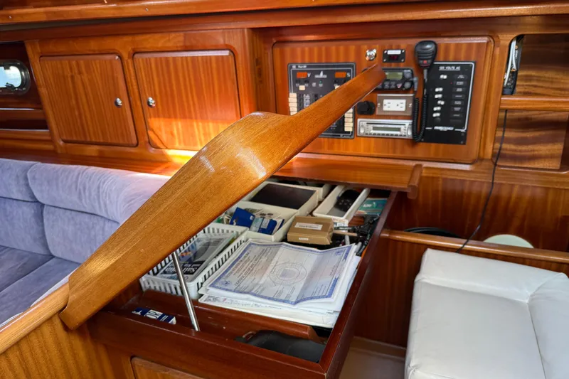Slide: The Image of Interior of 2002 Bavaria 37 Sloop with navigation station and wooden cabinetry. - 24