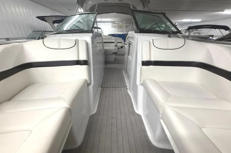 Slide: The Image of 2013 Formula 310 Bowrider interior with white seating and sleek design. - 12