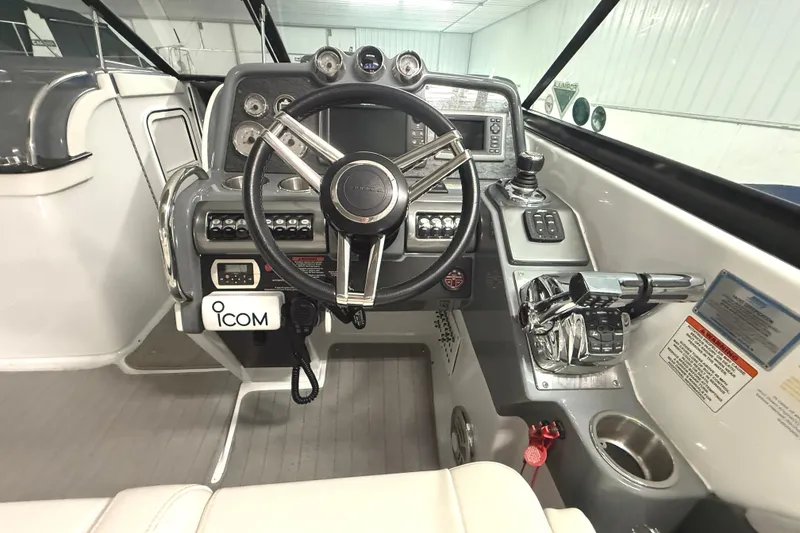 Slide: The Image of 2013 Formula 310 Bowrider helm with steering wheel, controls, and ICOM radio. - 14