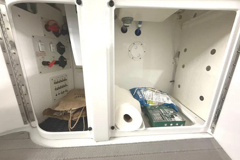Slide: The Image of 2013 Formula 310 Bowrider storage compartment with supplies and control panel. - 18