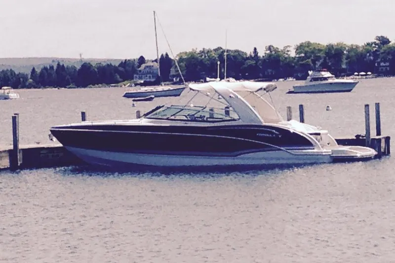 Slide: The Image of 2013 Formula 310 Bowrider docked on a calm lake. - 2