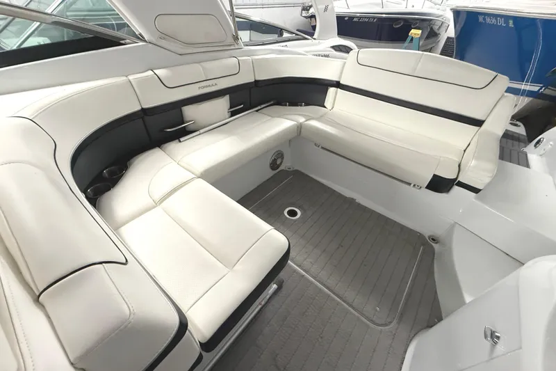 Slide: The Image of Luxurious seating area on a 2013 Formula 310 Bowrider boat, featuring white upholstery. - 21
