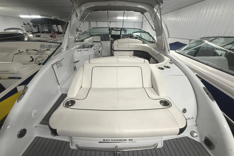 Slide: The Image of 2013 Formula 310 Bowrider boat interior with white seating, docked in Bay Harbor, MI. - 24