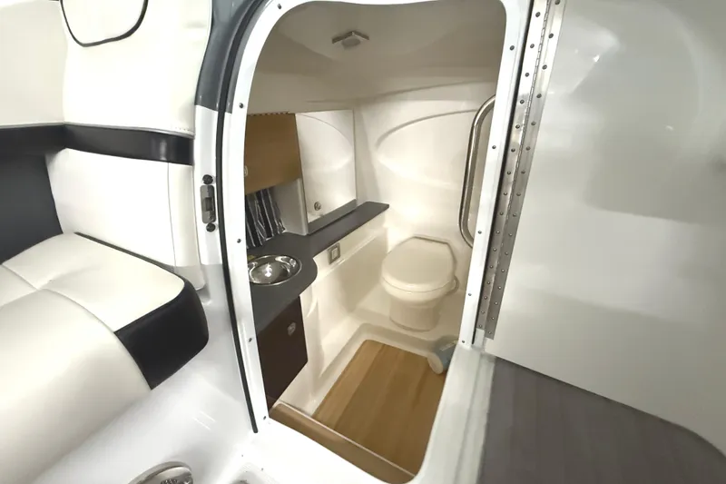 Slide: The Image of 2013 Formula 310 Bowrider interior with compact bathroom and seating area. - 25
