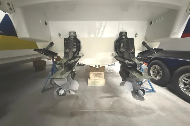 Slide: The Image of 2013 Formula 310 Bowrider boat with dual propellers in a garage setting. - 27
