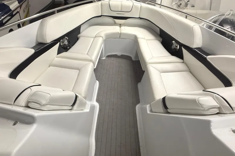 Slide: The Image of 2013 Formula 310 Bowrider interior with luxurious white seating and sleek design. - 9