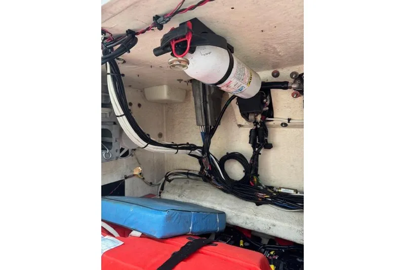 Slide: The Image of Engine compartment of a 1997 Sea Cat 255 boat with wiring and fire extinguisher. - 13