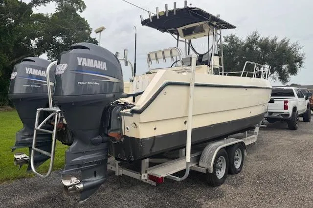 Slide: The Image of 1997 Sea Cat 255 boat with twin Yamaha engines on a trailer. - 2