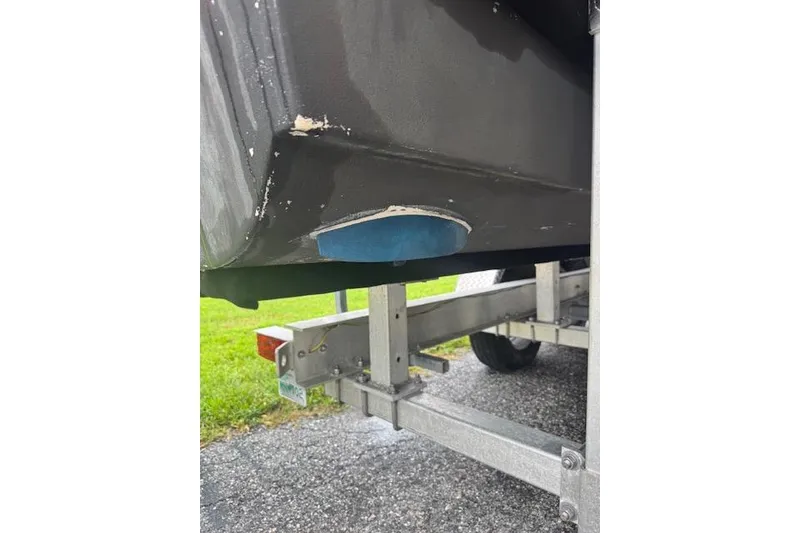 Slide: The Image of 1997 Sea Cat 255 boat on trailer, showing hull detail and trailer structure. - 21