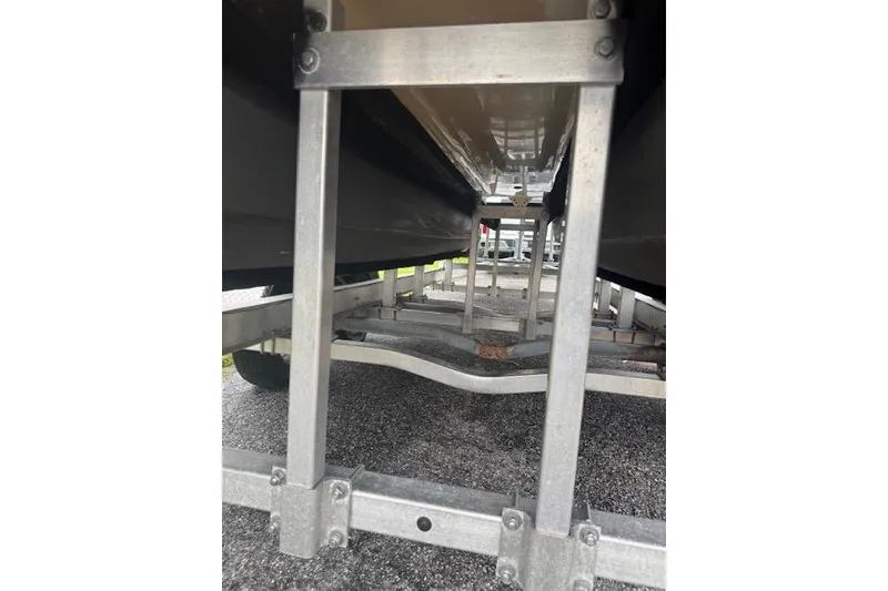 Slide: The Image of Underneath view of a 1997 Sea Cat 255 boat on a trailer. - 22