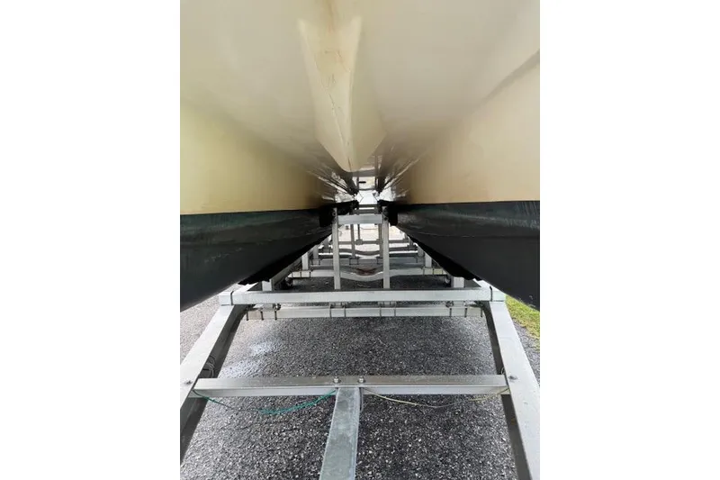 Slide: The Image of Underneath view of a 1997 Sea Cat 255 boat on a trailer. - 4