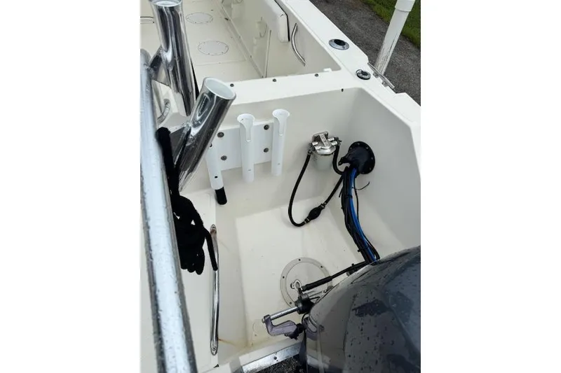 Slide: The Image of 1997 Sea Cat 255 boat interior with rod holders and engine connections. - 6