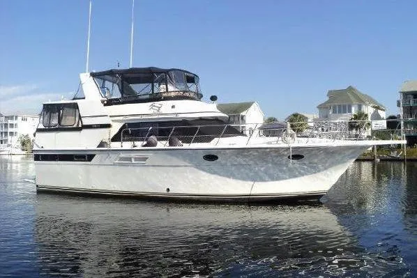 The Image of 1990 Californian 45 Motor Yacht on calm water, featuring sleek design and spacious deck. - 0