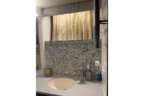 Slide: The Image of Bathroom sink area in a 1990 Californian 45 Motor Yacht with mosaic tile backsplash. - 14