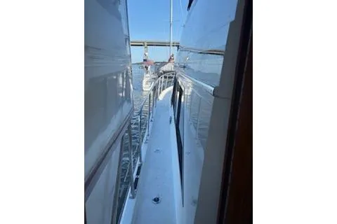 Slide: The Image of 1990 Californian 45 Motor Yacht on water, side view with bridge in background. - 20