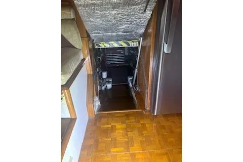 Slide: The Image of 1990 Californian 45 Motor Yacht interior with wooden flooring and engine room access. - 21