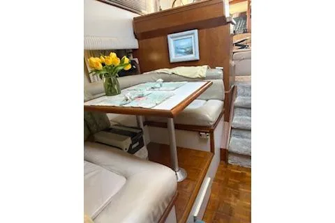 Slide: The Image of Interior of 1990 Californian 45 Motor Yacht with cozy dining area and floral decor. - 22