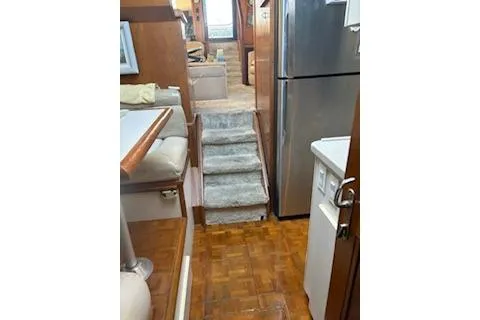 Slide: The Image of 1990 Californian 45 Motor Yacht interior with stairs, wood flooring, and modern appliances. - 23