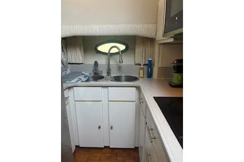 Slide: The Image of 1990 Californian 45 Motor Yacht kitchen with sink, cabinets, and appliances. - 24