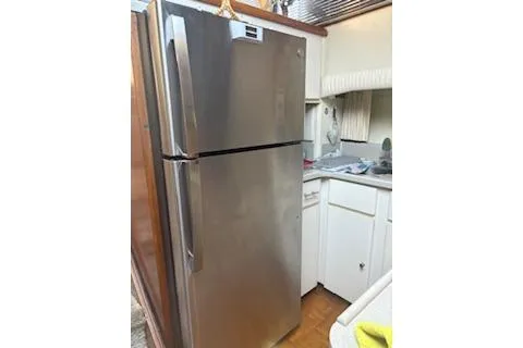 Slide: The Image of Stainless steel refrigerator in a 1990 Californian 45 Motor Yacht kitchen. - 25