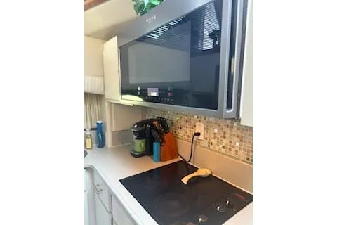 Slide: The Image of Kitchen area in a 1990 Californian 45 Motor Yacht with modern appliances. - 27