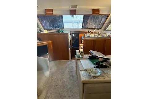 Slide: The Image of 1990 Californian 45 Motor Yacht interior with cozy seating and elegant wood finishes. - 29