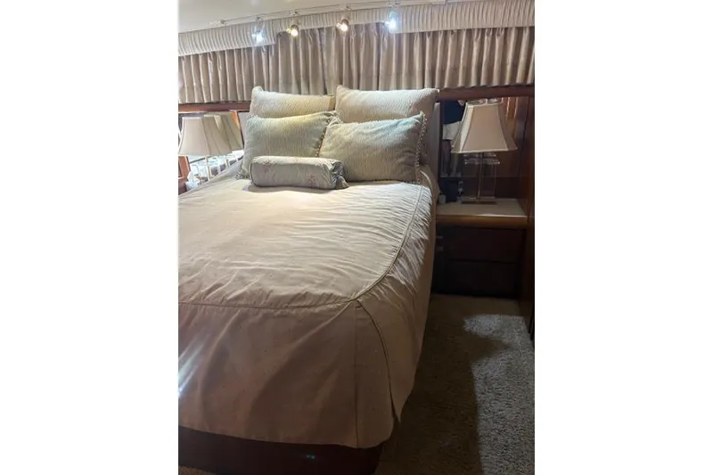 Slide: The Image of Luxurious bedroom interior of 1990 Californian 45 Motor Yacht with elegant bedding and lighting. - 3