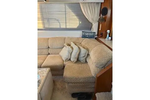 Slide: The Image of 1990 Californian 45 Motor Yacht interior with beige sofa, cushions, and window blinds. - 31