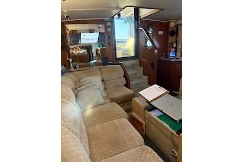 Slide: The Image of Interior of 1990 Californian 45 Motor Yacht with cozy seating and wooden accents. - 32