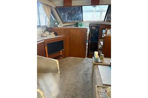 Slide: The Image of Interior of a 1990 Californian 45 Motor Yacht with cozy seating and decor. - 34