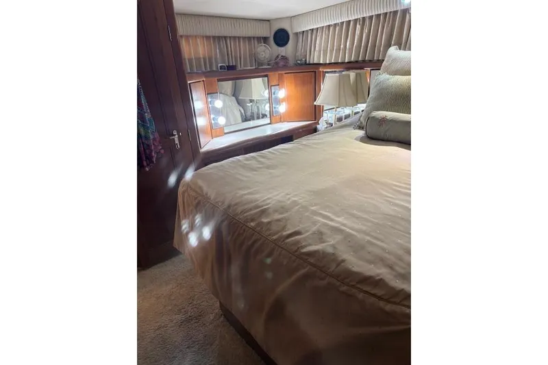 Slide: The Image of Luxurious bedroom interior of 1990 Californian 45 Motor Yacht with elegant decor and lighting. - 4