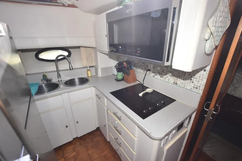 Slide: The Image of Compact kitchen in a 1990 Californian 45 Motor Yacht with modern appliances and dual sinks. - 40