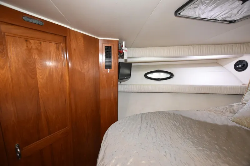 Slide: The Image of Interior cabin of 1990 Californian 45 Motor Yacht with wood paneling and porthole. - 42