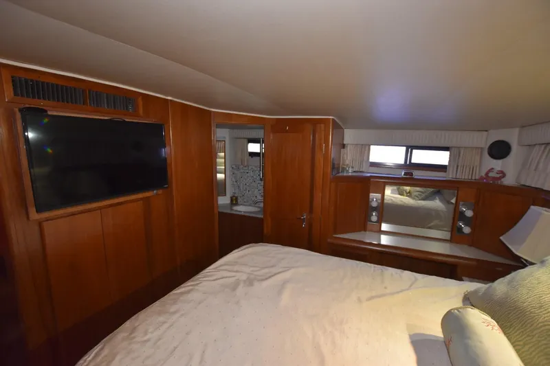 Slide: The Image of Luxurious cabin interior of 1990 Californian 45 Motor Yacht with wood paneling and TV. - 48