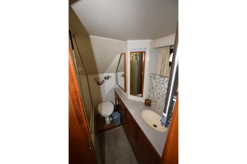 Slide: The Image of Bathroom interior of 1990 Californian 45 Motor Yacht with sink, toilet, and mirror. - 49